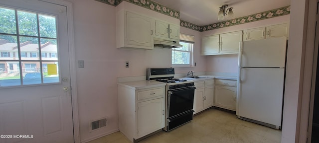 23 Primrose Ln, Brick, NJ 08724 - kitchen with freestanding refrigerator, range with gas stovetop, under cabinet range hood, and white cabinetry