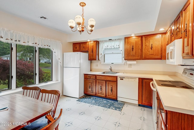 231 Valley Forge Dr, Little Egg Harbor, NJ 08087 - kitchen with white appliances, a chandelier, brown cabinetry, light countertops, and recessed lighting