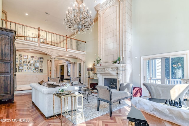 2 Red Oak, Holmdel, NJ 07733 - living room with a high ceiling, ornate columns, a chandelier, a fireplace, and recessed lighting