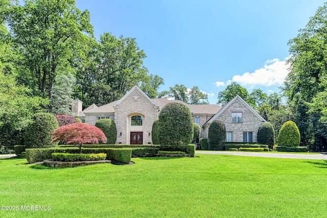 2 Red Oak, Holmdel, NJ 07733 - view of front of home featuring a front lawn, stone siding, a chimney, and brick siding