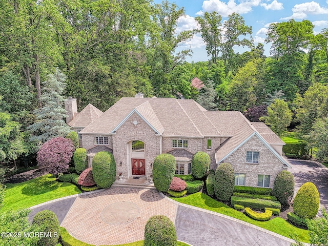 2 Red Oak, Holmdel, NJ 07733 - view of front facade featuring curved driveway, a chimney, and brick siding