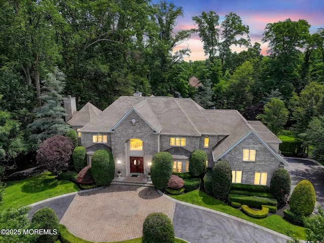 2 Red Oak, Holmdel, NJ 07733 - view of front of home featuring stone siding, curved driveway, and a chimney