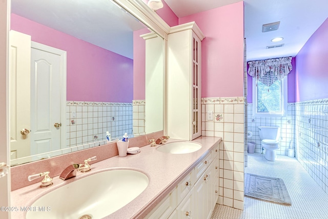 2 Red Oak, Holmdel, NJ 07733 - bathroom with tile walls, tile patterned floors, wainscoting, and double vanity