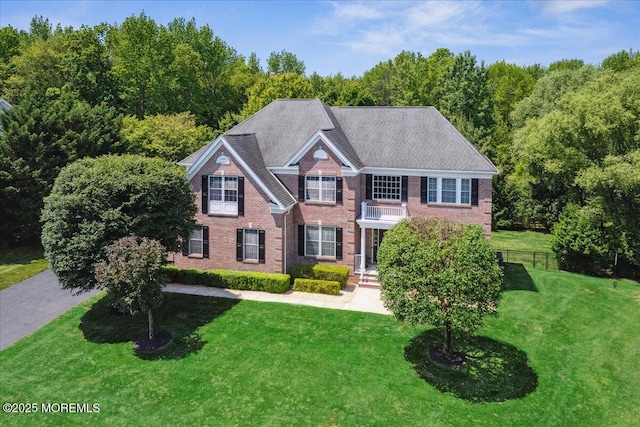 24 Rutledge Rd, Marlboro, NJ 07746 - colonial house with a balcony and brick siding