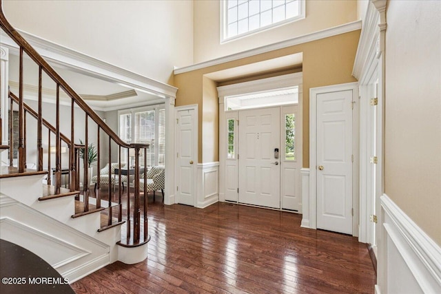 24 Rutledge Rd, Marlboro, NJ 07746 - foyer entrance featuring a wainscoted wall, healthy amount of natural light, hardwood / wood-style floors, stairs, and a decorative wall