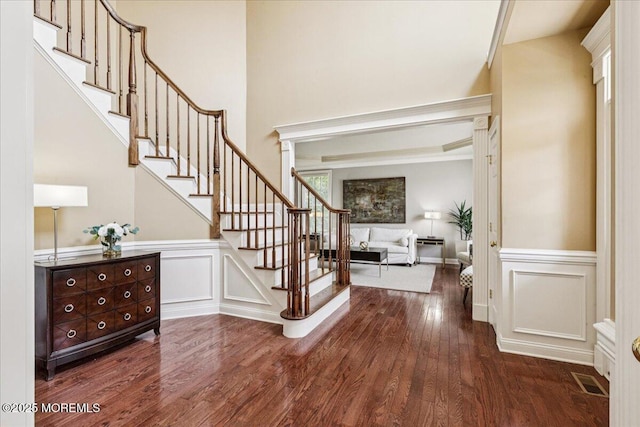24 Rutledge Rd, Marlboro, NJ 07746 - entryway with stairway, wood finished floors, a decorative wall, and a wainscoted wall