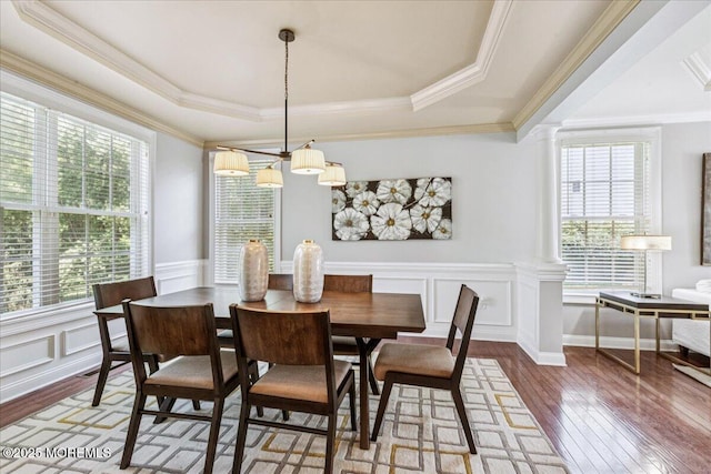 24 Rutledge Rd, Marlboro, NJ 07746 - dining area featuring hardwood / wood-style floors, a tray ceiling, ornamental molding, a wainscoted wall, and ornate columns