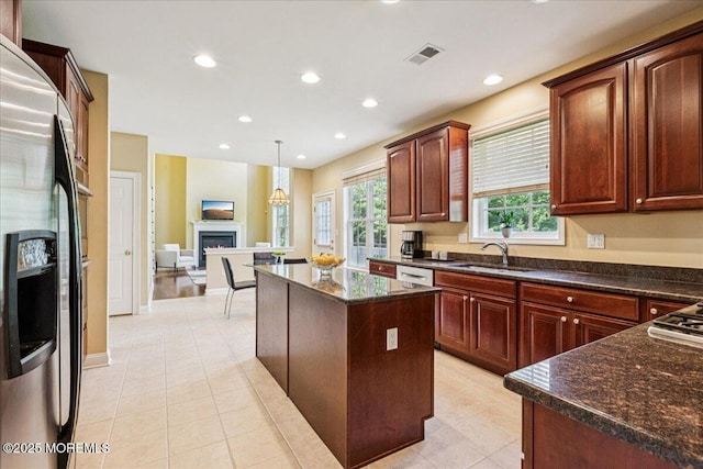 24 Rutledge Rd, Marlboro, NJ 07746 - kitchen featuring stainless steel fridge with ice dispenser, a center island, a lit fireplace, dark stone counters, and white dishwasher