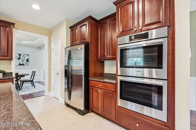 24 Rutledge Rd, Marlboro, NJ 07746 - kitchen featuring stainless steel appliances, dark stone counters, light tile patterned floors, wainscoting, and recessed lighting
