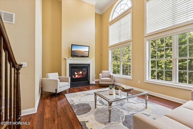 24 Rutledge Rd, Marlboro, NJ 07746 - living room with crown molding, a fireplace with flush hearth, dark wood-style floors, and a high ceiling