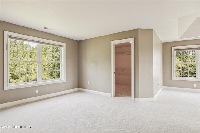 24 Rutledge Rd, Marlboro, NJ 07746 - unfurnished bedroom featuring multiple windows, carpet flooring, a walk in closet, and a closet