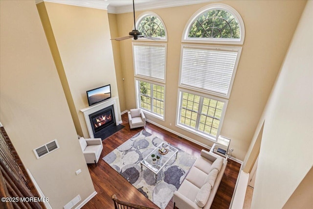 24 Rutledge Rd, Marlboro, NJ 07746 - living area with a fireplace with flush hearth, a towering ceiling, crown molding, ceiling fan, and dark wood finished floors