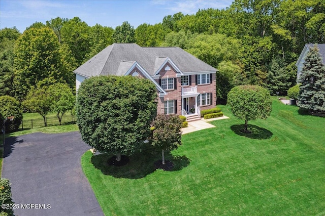24 Rutledge Rd, Marlboro, NJ 07746 - colonial-style house featuring asphalt driveway and brick siding