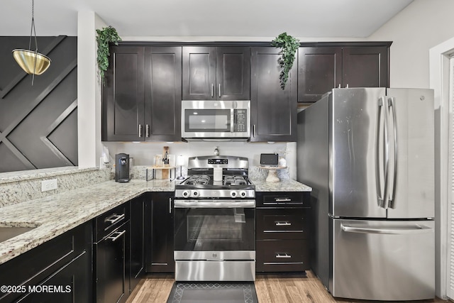 518 Tavern Rd, Monroe, NJ 08831 - kitchen with stainless steel appliances, light wood-style flooring, and light stone countertops