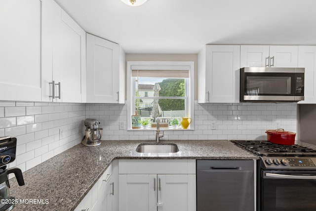 81 Lockwood Ave, Woodbridge, NJ 07095 - kitchen with stainless steel appliances, white cabinetry, backsplash, and dark stone countertops