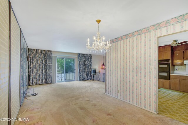 16 Burdge Dr, Howell, NJ 07731 - unfurnished room with wallpapered walls, a chandelier, light colored carpet, and ceiling fan