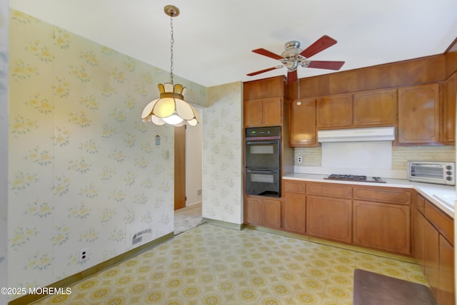 16 Burdge Dr, Howell, NJ 07731 - kitchen featuring under cabinet range hood, light countertops, ceiling fan, pendant lighting, and brown cabinets
