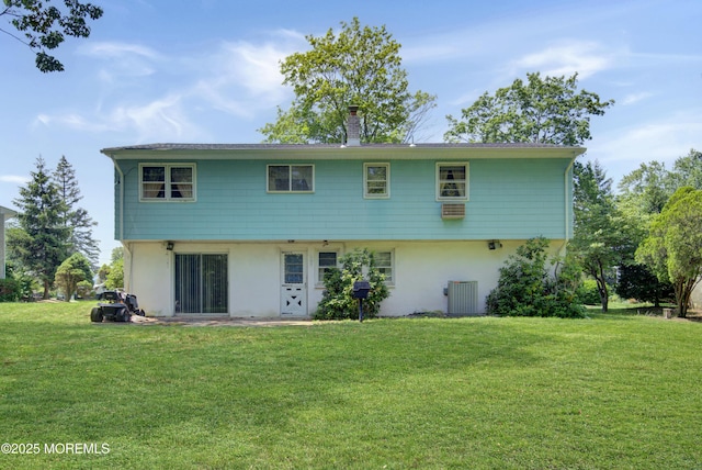 16 Burdge Dr, Howell, NJ 07731 - rear view of house featuring stucco siding, a lawn, and a chimney