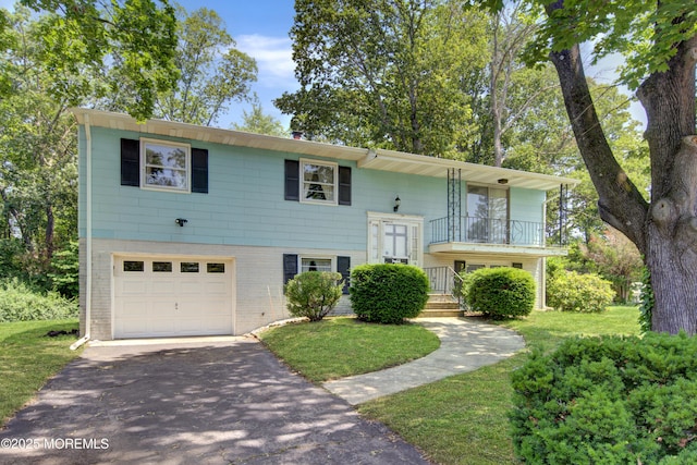 16 Burdge Dr, Howell, NJ 07731 - raised ranch with an attached garage, driveway, a balcony, a front yard, and brick siding
