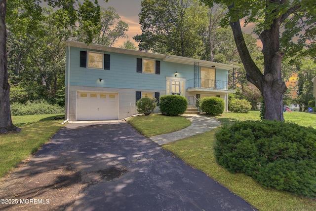 16 Burdge Dr, Howell, NJ 07731 - split foyer home with driveway, an attached garage, a yard, and brick siding