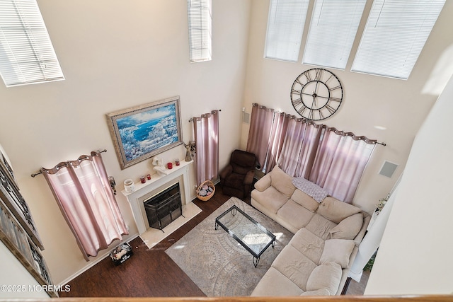 15 Savannah Dr, Barnegat, NJ 08005 - living room featuring wood finished floors, a tiled fireplace, and a towering ceiling