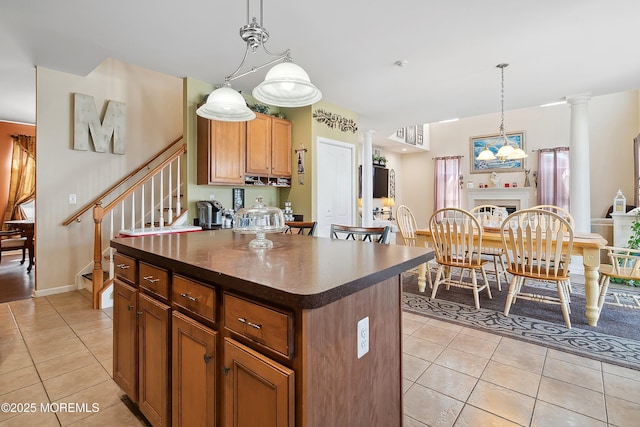 15 Savannah Dr, Barnegat, NJ 08005 - kitchen with light tile patterned flooring, dark countertops, ornate columns, and a center island