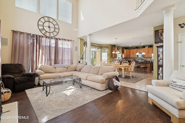 15 Savannah Dr, Barnegat, NJ 08005 - living room with ornate columns, wood finished floors, and a towering ceiling