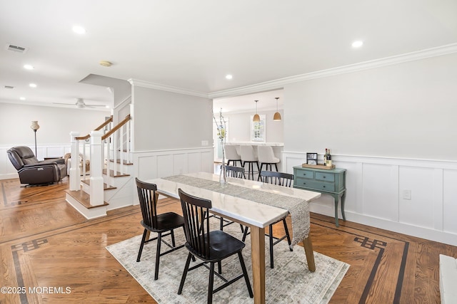 1810 Shore Blvd, Point Pleasant, NJ 08742 - dining area with wainscoting, a ceiling fan, ornamental molding, stairway, and a decorative wall
