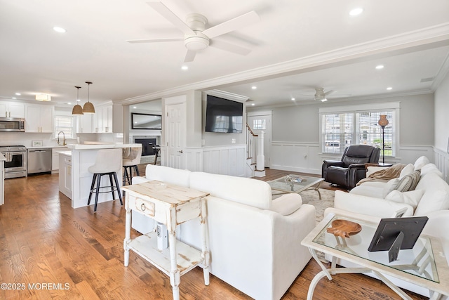 1810 Shore Blvd, Point Pleasant, NJ 08742 - living area with ceiling fan, ornamental molding, healthy amount of natural light, stairway, and wainscoting