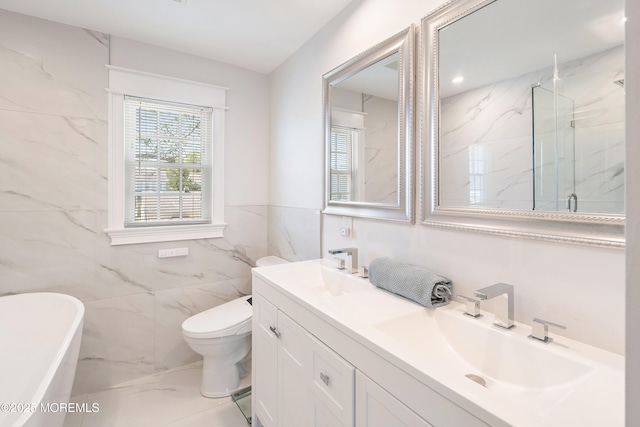 1810 Shore Blvd, Point Pleasant, NJ 08742 - bathroom featuring double vanity, a freestanding bath, a marble finish shower, tile walls, and marble finish floors