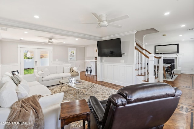 1810 Shore Blvd, Point Pleasant, NJ 08742 - living area with a ceiling fan, ornamental molding, a brick fireplace, a decorative wall, and wainscoting