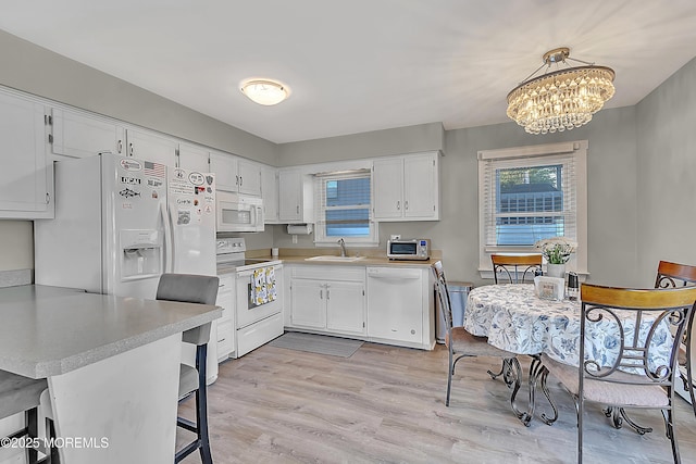 4 Longpoint Dr, Brick, NJ 08723 - kitchen featuring white appliances, light countertops, white cabinetry, a chandelier, and light wood finished floors