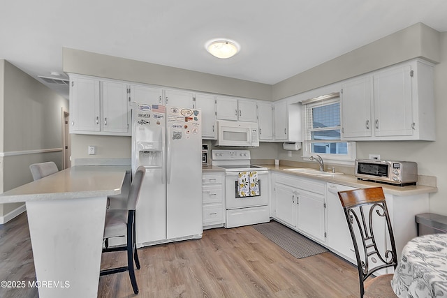 4 Longpoint Dr, Brick, NJ 08723 - kitchen with white appliances, light wood-style floors, light countertops, white cabinetry, and a kitchen breakfast bar