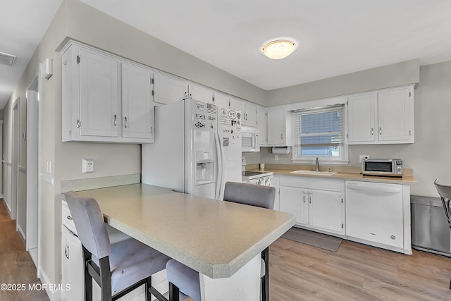 4 Longpoint Dr, Brick, NJ 08723 - kitchen with white appliances, light wood-style flooring, a peninsula, light countertops, and white cabinets
