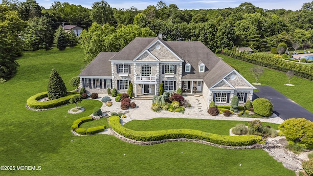 1 Ethan Dr, Farmingdale, NJ 07727 - view of front of house with stone siding, a balcony, and a front yard