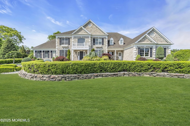 1 Ethan Dr, Farmingdale, NJ 07727 - colonial home with stone siding, a front yard, and a balcony