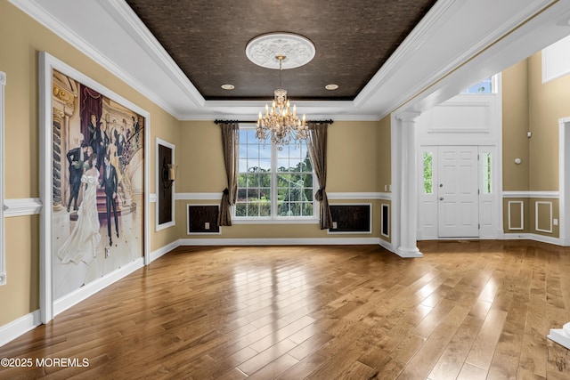 1 Ethan Dr, Farmingdale, NJ 07727 - unfurnished living room with a tray ceiling, a chandelier, wood finished floors, crown molding, and wainscoting