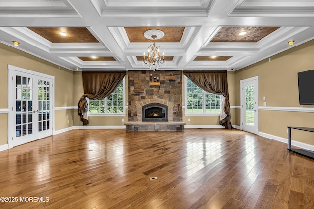 1 Ethan Dr, Farmingdale, NJ 07727 - unfurnished living room with a chandelier, healthy amount of natural light, french doors, wood-type flooring, and ornamental molding