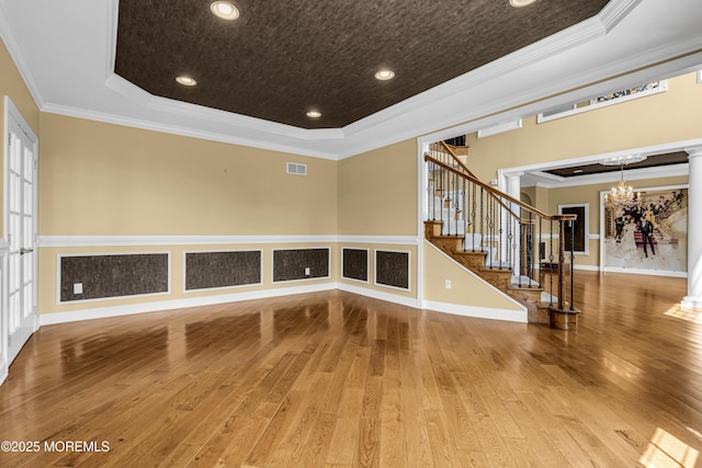 1 Ethan Dr, Farmingdale, NJ 07727 - empty room with a tray ceiling, hardwood / wood-style floors, ornamental molding, stairs, and a chandelier