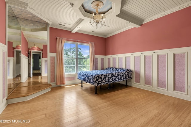 1 Ethan Dr, Farmingdale, NJ 07727 - bedroom featuring a chandelier, light wood-style floors, wainscoting, a decorative wall, and beam ceiling