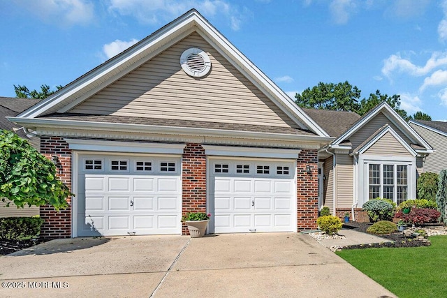 24 Oakmont Ln, Jackson, NJ 08527 - view of front of house with driveway, brick siding, a garage, and a shingled roof