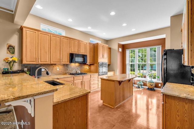 24 Oakmont Ln, Jackson, NJ 08527 - kitchen with black appliances, a kitchen bar, recessed lighting, light stone countertops, and tasteful backsplash