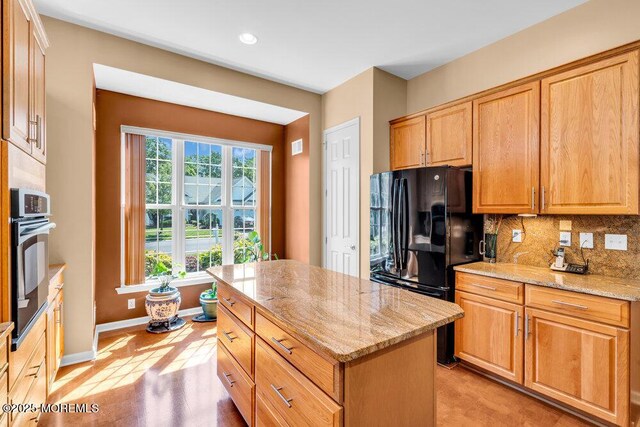 24 Oakmont Ln, Jackson, NJ 08527 - kitchen featuring black appliances, light stone countertops, decorative backsplash, a center island, and recessed lighting