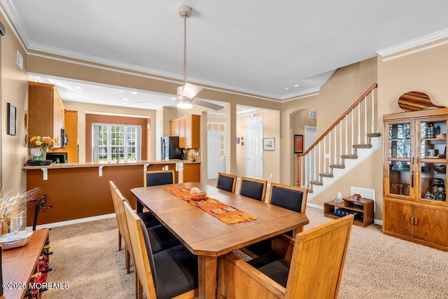 24 Oakmont Ln, Jackson, NJ 08527 - dining room featuring light colored carpet, stairs, crown molding, ceiling fan, and arched walkways