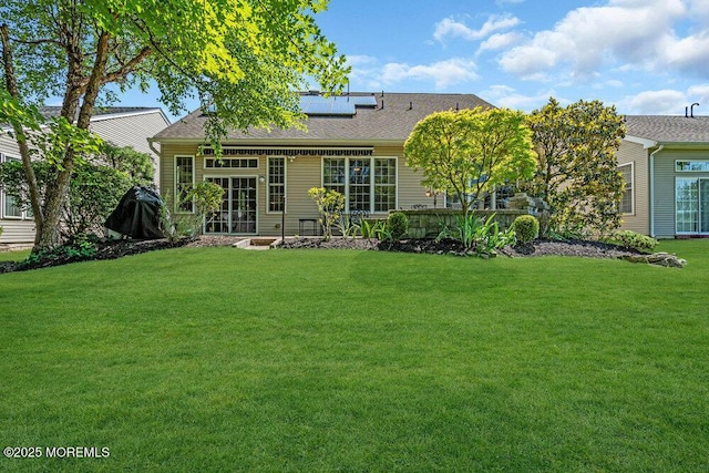 24 Oakmont Ln, Jackson, NJ 08527 - back of property with solar panels, a yard, and roof with shingles