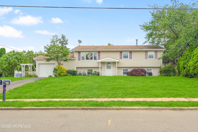 353 Cokes Dr, Toms River, NJ 08753 - bi-level home with a front lawn, asphalt driveway, and a garage