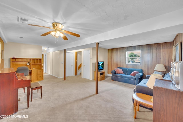 353 Cokes Dr, Toms River, NJ 08753 - living room featuring light carpet, ceiling fan, wooden walls, and stairway