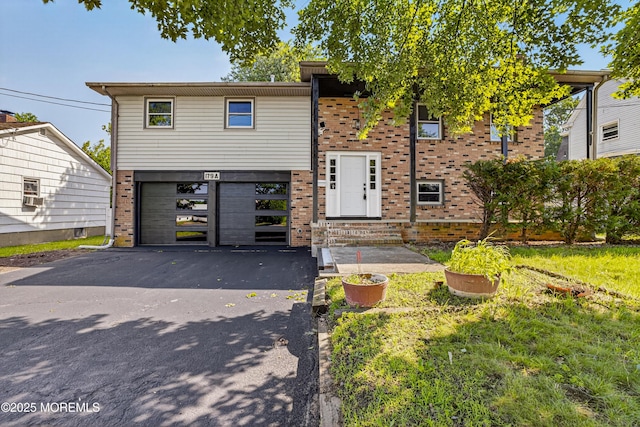 179A Buckelew Ave Unit A, Jamesburg, NJ 08831 - view of front of property featuring brick siding, asphalt driveway, and a garage