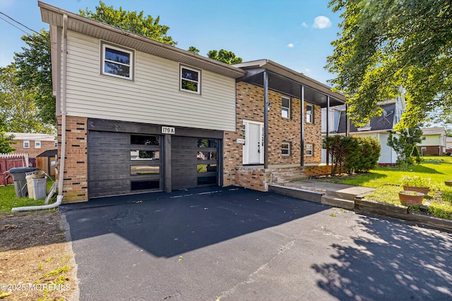 179A Buckelew Ave Unit A, Jamesburg, NJ 08831 - view of front of property with brick siding, an attached garage, and driveway