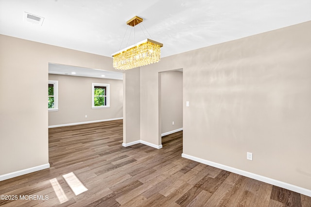 179A Buckelew Ave Unit A, Jamesburg, NJ 08831 - spare room featuring a chandelier and wood finished floors